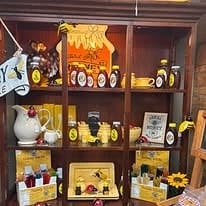Shelf of local gifts, honey and cheerful decor inside Edge of Town