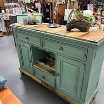Painted green cabinet and unique decor inside Edge of Town